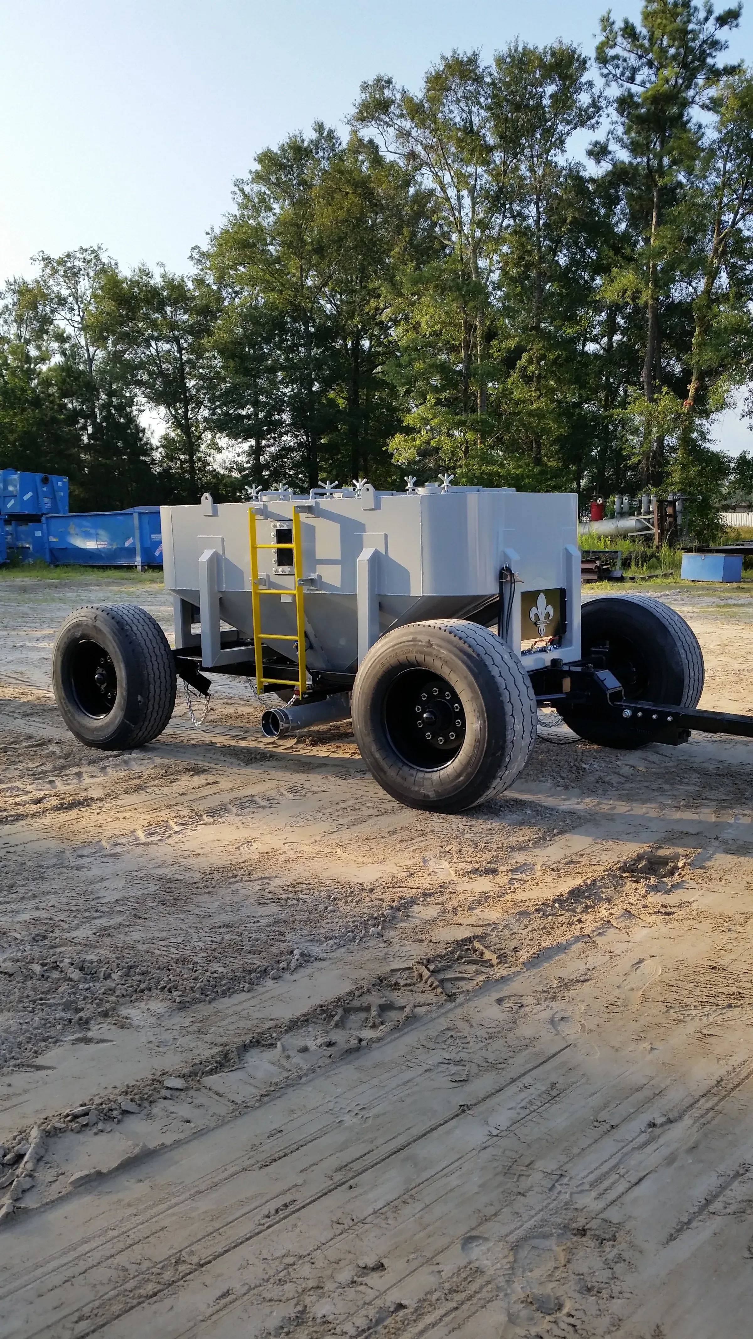 Cone-bottom tank trailer staged in the yard, ready to move recovered material