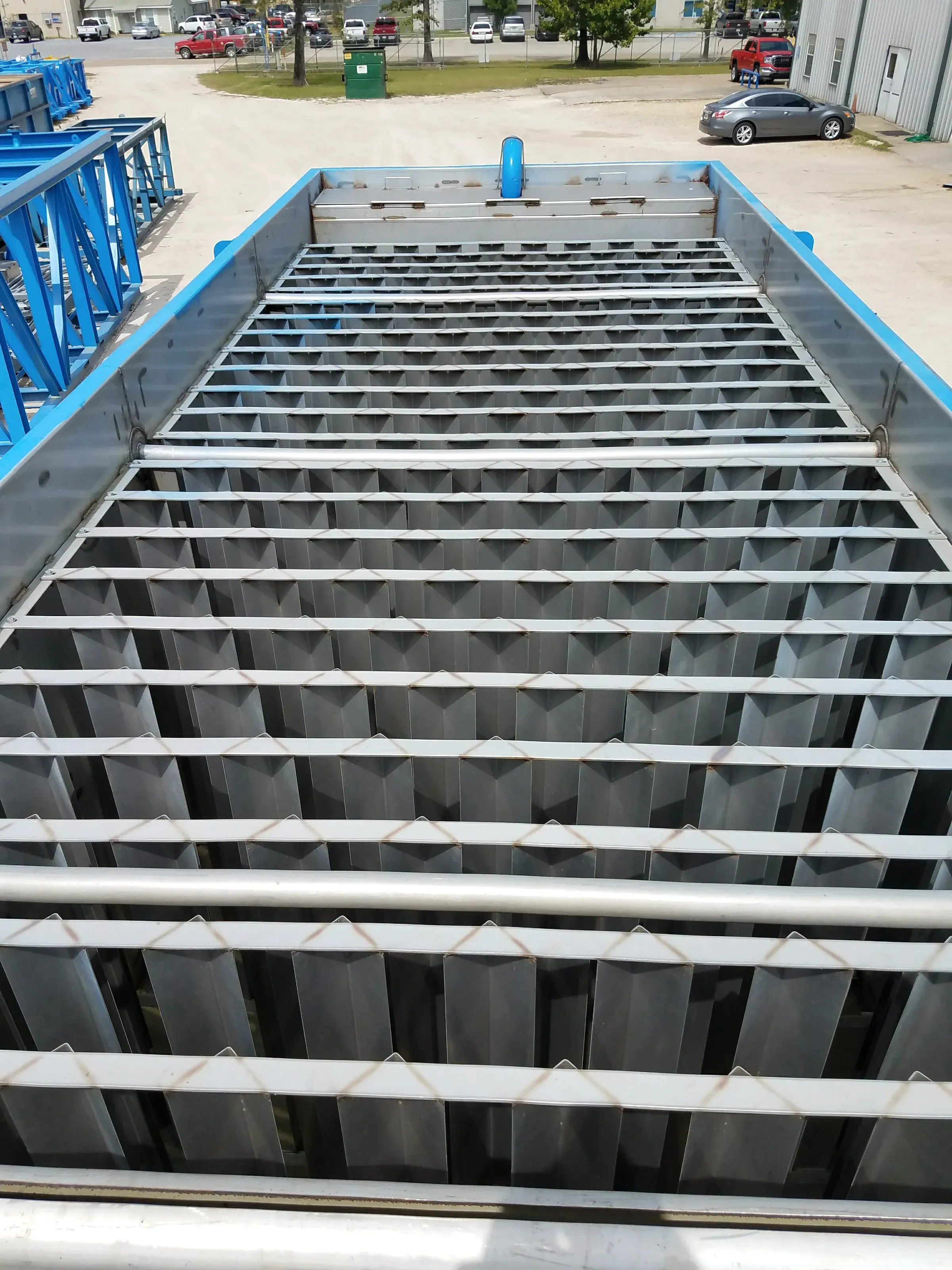 Close view of the stainless lamella plate pack inside a blue clarifier body