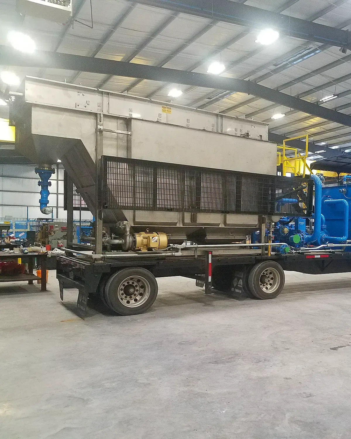 Stainless mobile DAF unit loaded on a lowboy trailer in the fabrication shop